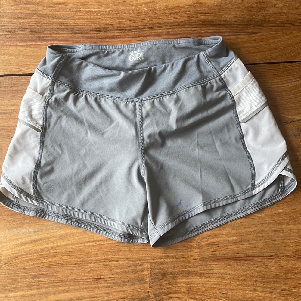 Athletic girl shorts, in size large/12, has blue paint stain